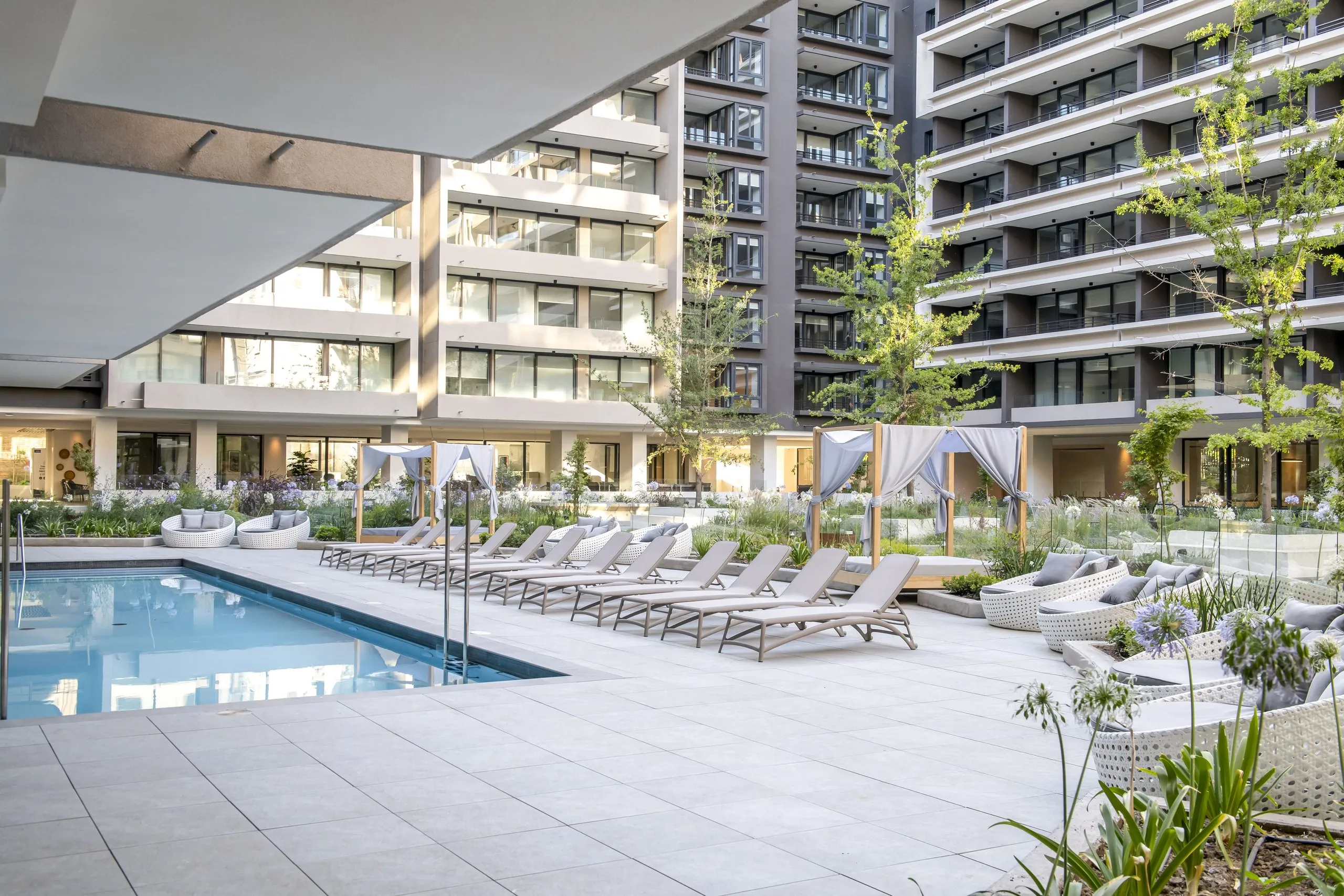 Piscina exterior y fachada del edificio SOMMA Inés de Suárez